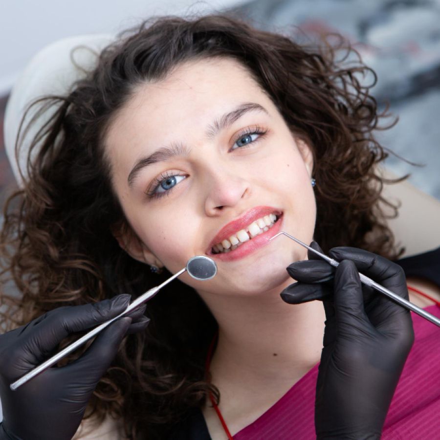 woman having a dental hygiene check up in a dentist chair