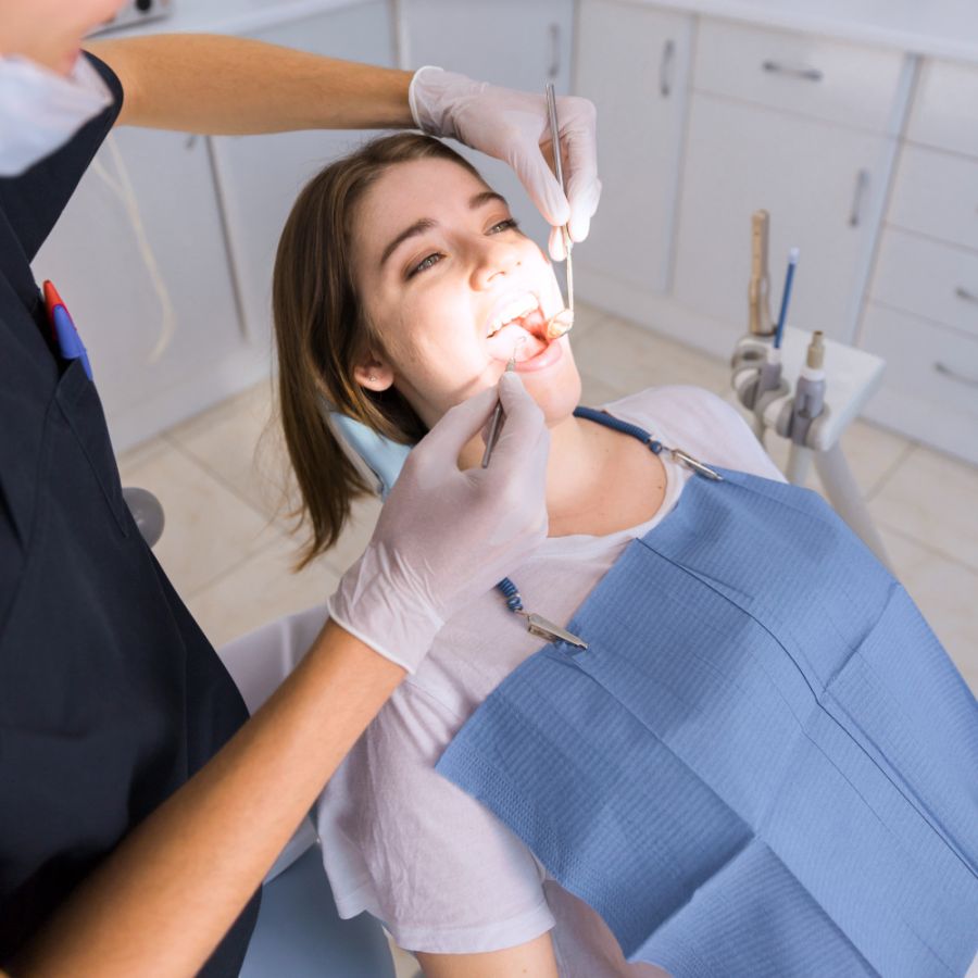 Woman at the dentist in the chair having a dental checkup